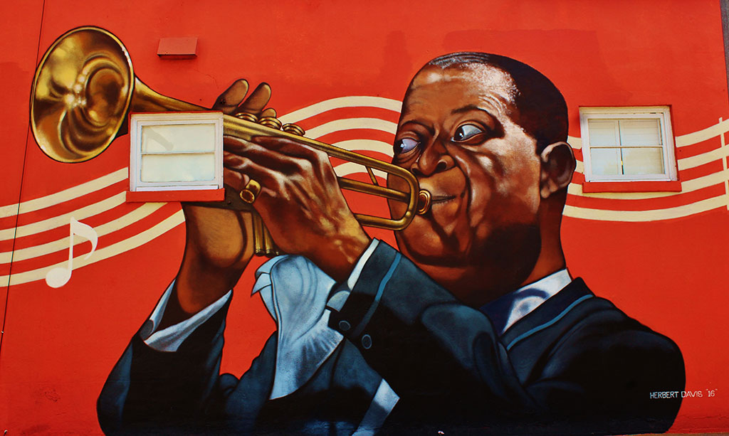 Images of the Great New Orleans horn player 'Satchmo' grace the sidewall on 9th street as you enter the FREE parking lot, and out door patio!